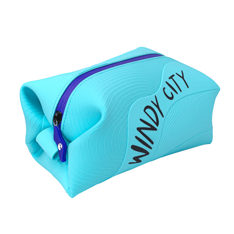 3/4 view of aqua silicone pouch with 3D wave texture, Windy City in black capitals on long side, blue plastic zipper