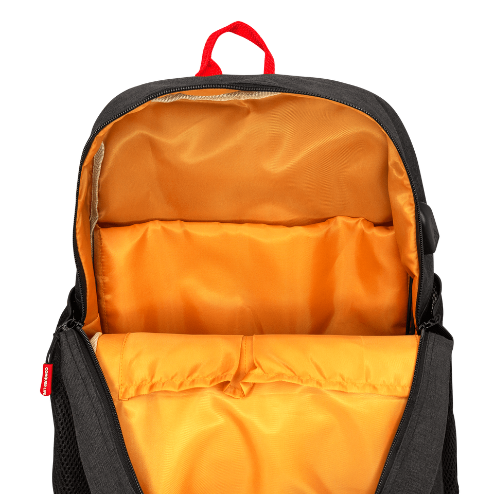 Inside view of poly-fabric backpack in navy blue: red handle on top, orange lining, 2 open pockets, padded 15" laptop sleeve