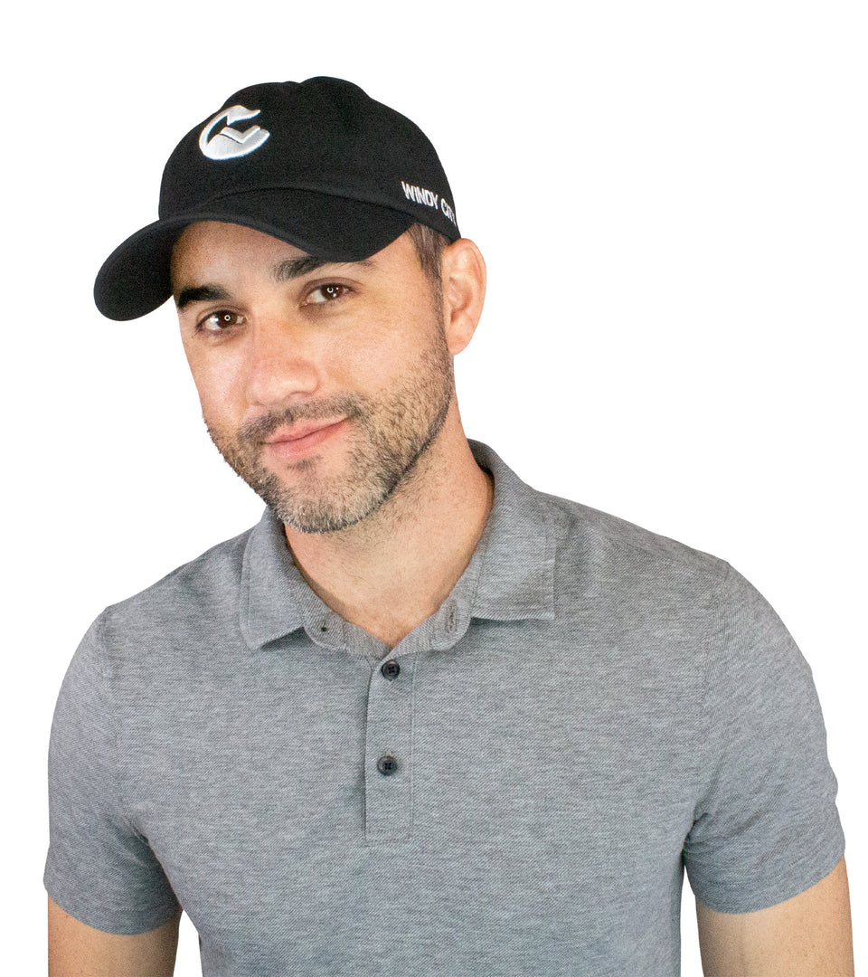 3/4 front view of male model in black cotton-nylon cap: white Conquer Life logo at front and white Conquer Life text on side