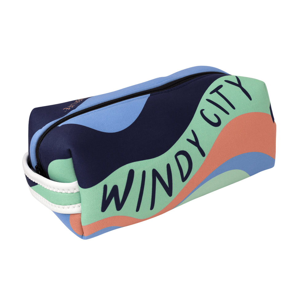 3/4 view of neoprene pouch: multicolor wave pattern & Windy City in dark blue capitals on long side, handle on short side