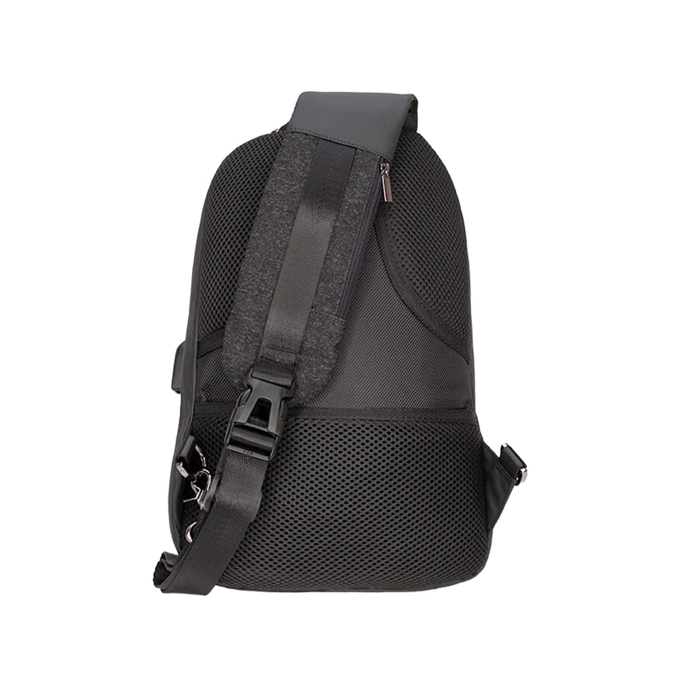 Rear view of black poly-fabric sling bag: mesh padding, metal keyrings, and sling strap with plastic buckle and zipper pocket