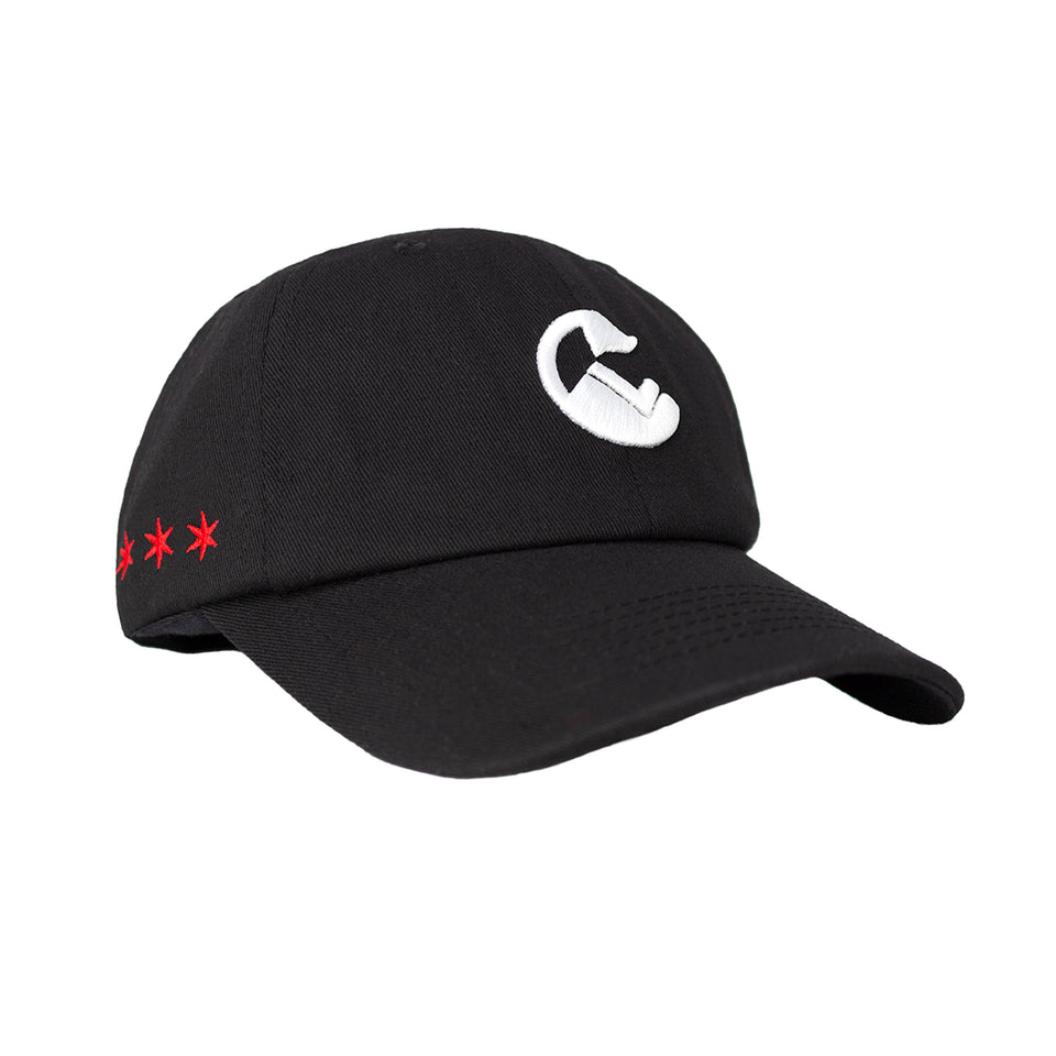 ¾ front view of black cotton-nylon baseball cap, white embroidered Conquer Life logo at the center, red stars on side