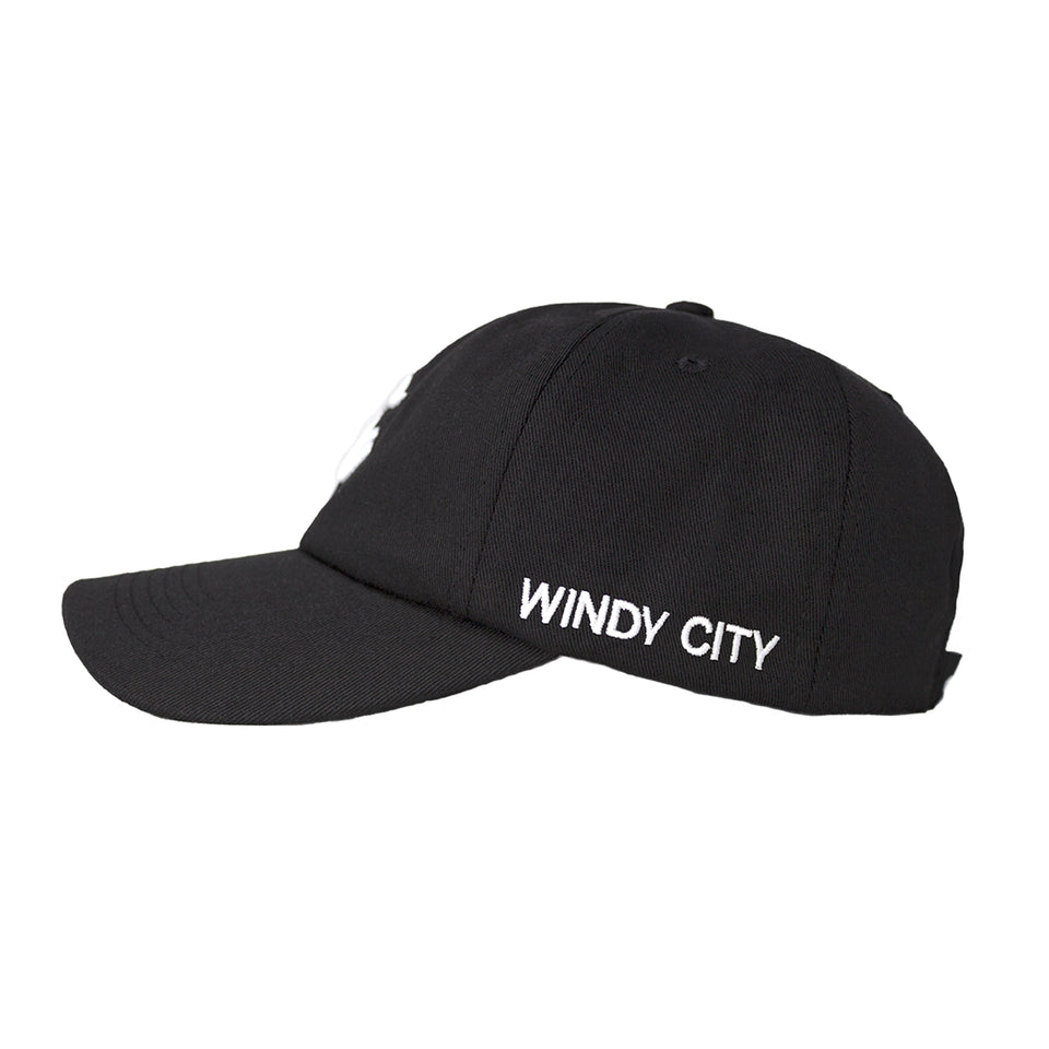 Left side of black cotton-nylon baseball cap, Windy City is embroidered in white capital letters on bottom edge